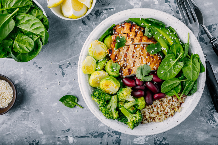 Healthy Buddha Bowl Lunch With Grilled Chicken, Quinoa, Spinach, Avocado, Brussels Sprouts, Broccoli, Red Beans With Sesame Seeds